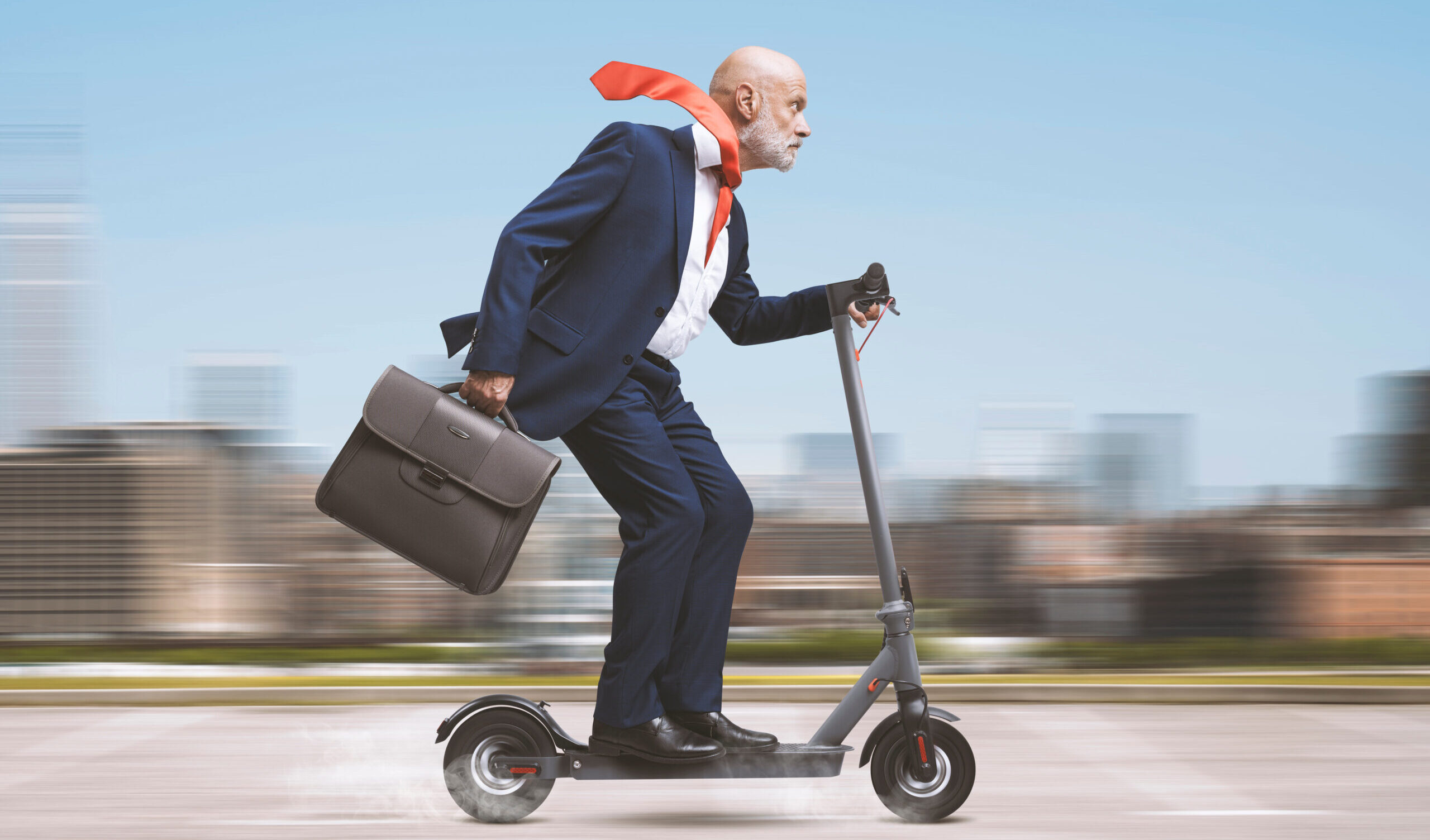 Corporate Businessman Riding A Scooter